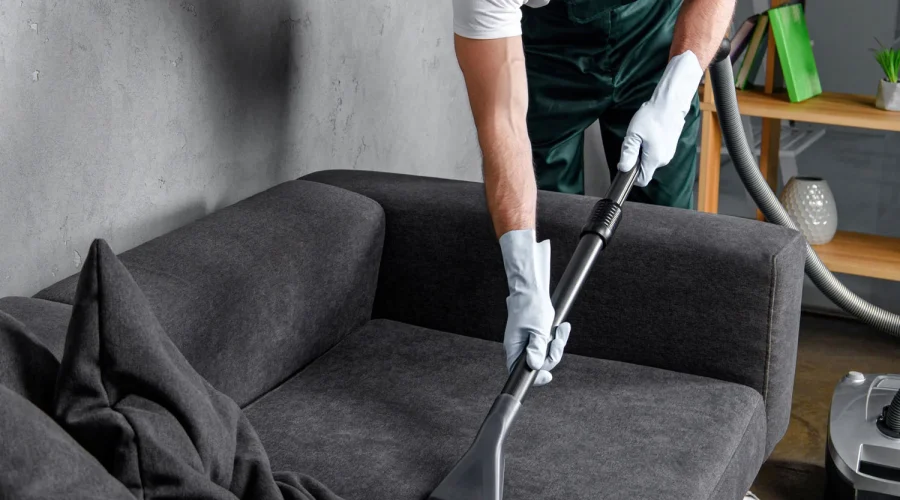 handsome-young-man-in-rubber-gloves-cleaning-furni-3.webp